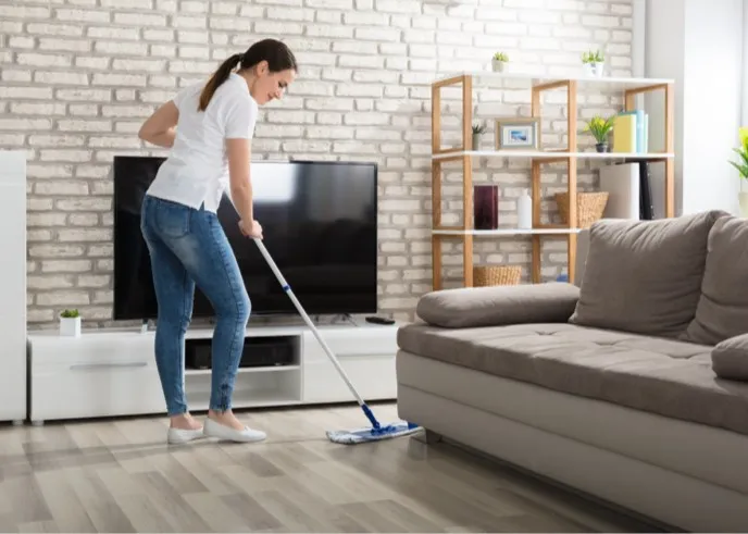Lady cleaning hardwood floor | Jubilee Flooring & Decorating